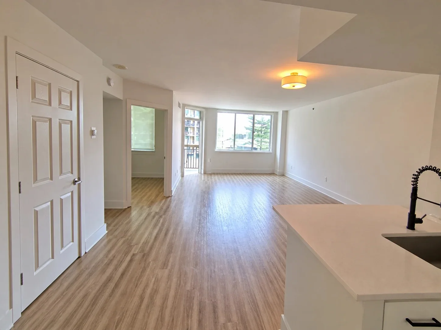An AI edit of the same frame with the furniture removed, made to illustrate an empty unit. Not a capture.